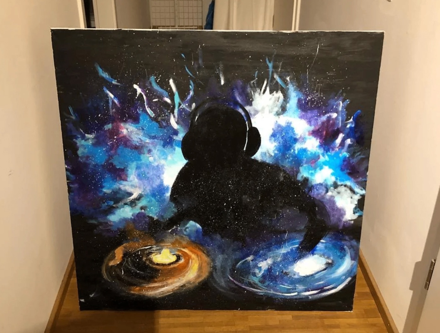 Figure in headphones against a cosmic blue-and-purple galaxy