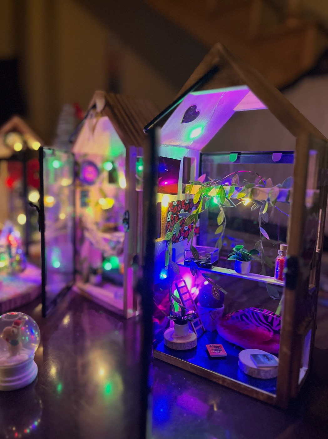 Handmade miniature house diorama glowing with fairy lights
